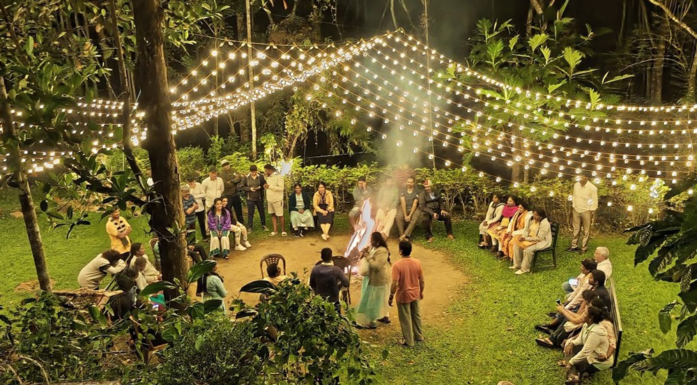 sitting around campfire under starlit Wayanad sky